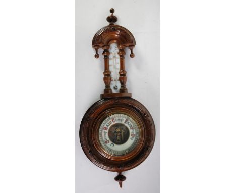 EARLY 20th CENTURY ANEROID BAROMETER AND THERMOMETER, in carved walnut wood case, having ceramic dial to the thermometer and 