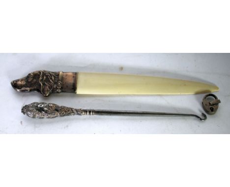 A POSSIBLY FRENCH WHITE METAL 'DOG'S HEAD' HANDLED BONE LETTER KNIFE, also a silver handled steel  button hook, the handle st