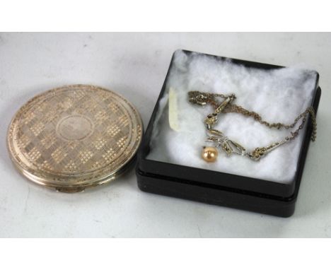 A KIGU LADY'S ENGINE TURNED SILVER CIRCULAR POWDER COMPACT, London 1949 and a BRIGHT METAL AND MARCASITE NECKLACE with one co