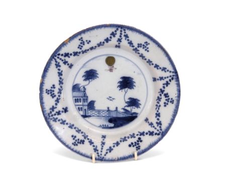 18th century English Delft plate of ballooning interest, the centre painted with a landscape in blue with a balloon painted i