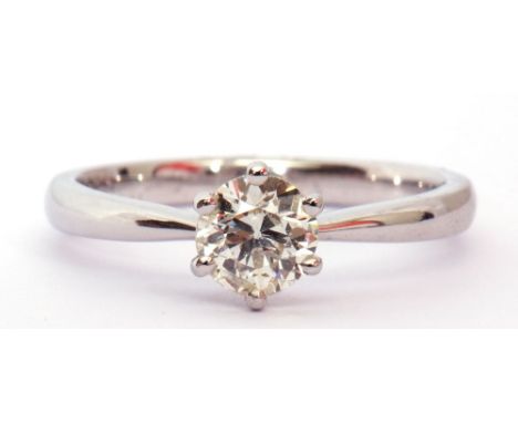 Single stone diamond ring, the round brilliant cut diamond 0.60ct approx, multi-claw set and raised between tapering shoulder