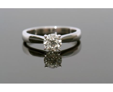 Single stone diamond ring, the brilliant cut diamond of 0.65ct approx, raised between upswept plain polished shoulders and sh