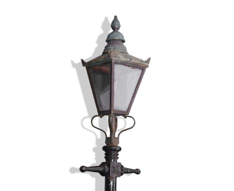 Victorian cast metal street lamp with a four glass tapering metal framed shade resting on a black anodised cast stand with em