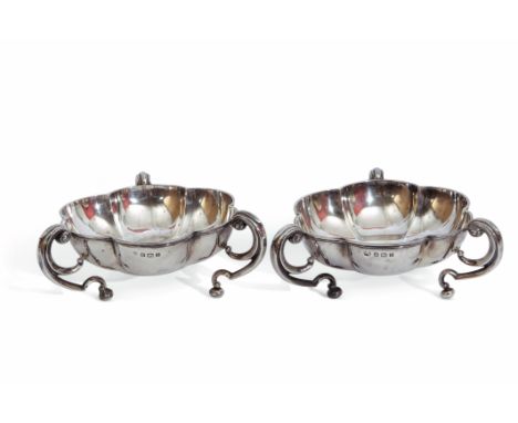 Pair of Edward VII silver bon-bon dishes of round lobed form, supported by three scroll handles terminating on ball feet, Bir