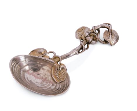 A cast silver and silver-gilt "mussel" caddy spoon, realistically modelled with a shell bowl, the scroll branch handle entwin