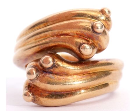 A large "750" stamped crossover ring, a stylised thread and bead design, size M/N, 14.8gms