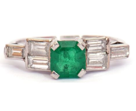 Emerald and diamond ring, the square emerald raised between stepped baguette set diamond shoulders, diamond carat weight 0.42