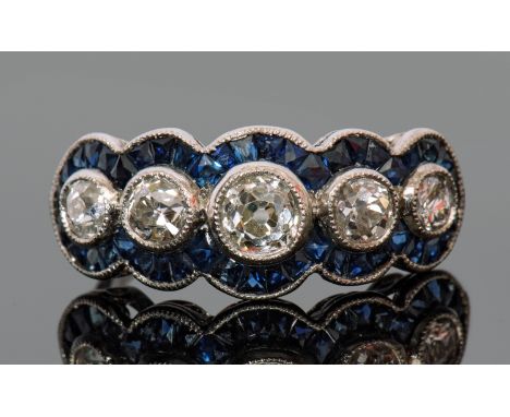 Diamond and sapphire dress ring, the feature old cut round diamond 0.25ct approx, flanked on either side by two smaller old c