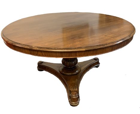 Early 19th century rosewood circular pedestal dining table with moulded edge over a moulded baluster support terminating in a