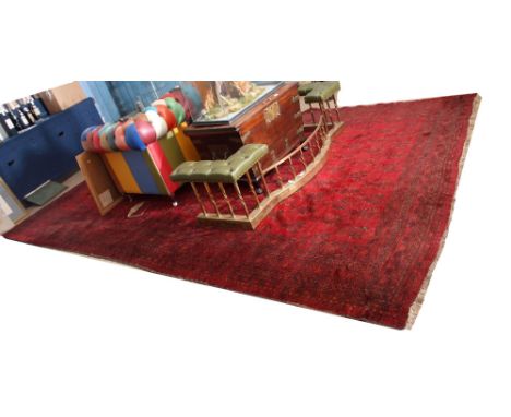 Late 20th century large Shiraz carpet (ex-Liberty &amp; Co), multi-gull border, central panel of floral sprigs, mainly red fi