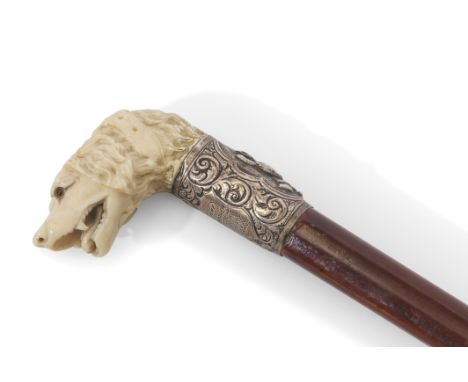 19th century hunting cane, the ivory handle carved in the form of a hound with glass or composition eyes, joined to a hallmar