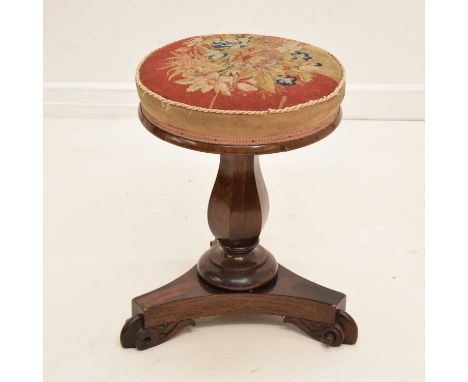 Victorian rosewood piano stool, with adjustable revolving tapestry seat, the baluster pedestal raised on concave tripartite b