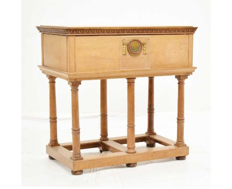Circa 1960s golden oak ecclesiastical chest of rectangular form with a hinged lid having egg and dart carving, standing on si