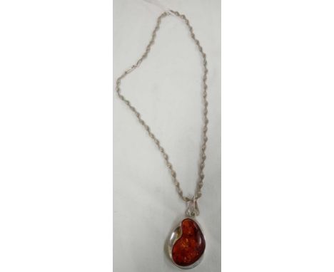 A RECONSTITUATED AMBER PENDANT ON SILVER CHAIN