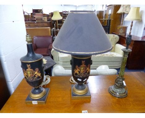 A PAIR OF EBONISED URN SHAPED TABLE LAMPS, with crest detail (one shade only) and another table lamp base (3)