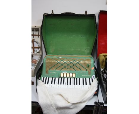 A CASED HOHNER PIANO ACCORDION, 'Virtuola III', in green