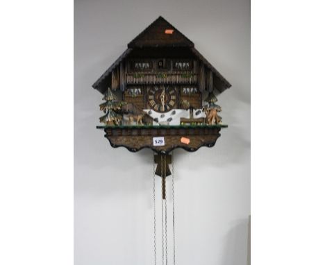 A CUCKOO CLOCK, in the form of a chalet, rack strike device, height approximately 41cm x width 39cm