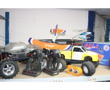 TWO TRAXXAS PETROL ENGINE 3-CHANNEL RADIO CONTROL CARS, a boxed E-Sky Helicopter and a boxed Air Pressure propelled plane (4)