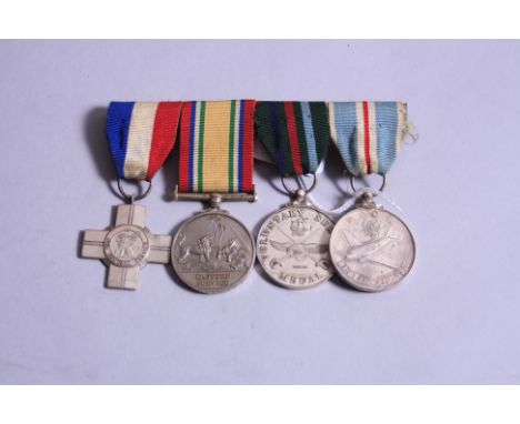 A GROUP OF FOUR COMMEMORATIVE MEDALS, on a wearing bar, General Service Cross (silver), Eastern Service medal Voluntary Servi