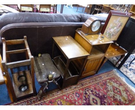 AN OAK LINENFOLD BEDSIDE CABINET, coffee table, camel stool, magazine rack/table, stick stand, firescreen and an oak mantle c