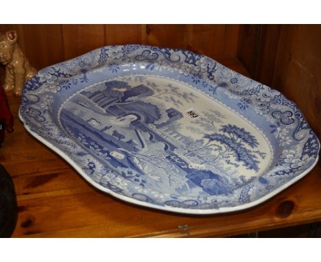 A LARGE 19TH CENTURY SPODE MEAT PLATTER, blue and white transfer castle pattern, figures passing through gateway to bridge be