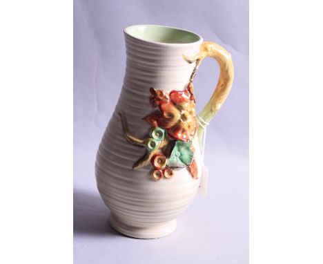 A CLARICE CLIFF JUG, decorated with embossed Autumn fruits, embossed signature to base and No.914, height approximately 21cm