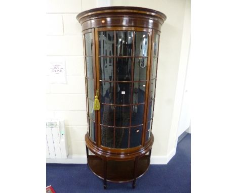 AN EDWARDIAN DEMI-LUNE DISPLAY CABINET, with single door, square tapering supports, under shelf and spade feet, approximate s