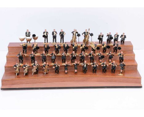 43pce Orchestra in Evening dress with a tiered wooden stage, standard 'Britains' 54mm scale loose figures, complete with musi