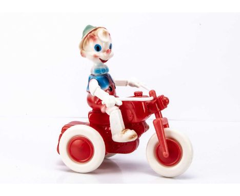 A 1960's Large Scale Polythene Plastic Buratino On Motorcycle Toy, featuring Pinocchio type figure seated on a free-wheeling 