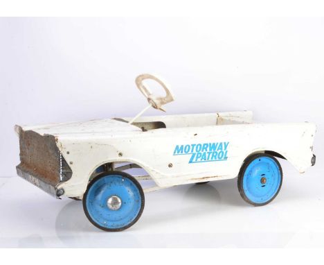 A 1960's Tri-ang Toys Motorway Patrol Pedal Car, pressed steel body in white with 'Motorway Patrol' logo in blue to doors, bl