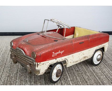 A 1950's Tri-ang Toys Zephyr Duotone Pedal Car, pressed steel body in red and white, bonnet lifts to reveal realistic engine 