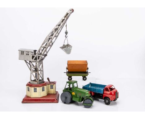 A Gely Tinplate Clockwork Dockyard Crane, silver crane with removable bucket, detailed tinprinted base featuring doors, windo