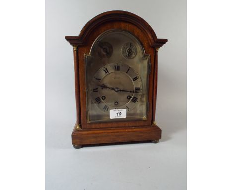 An Edwardian Arch Top Mantle Clock with Pilaster Supports by Diss and Sons, Dewsbury.