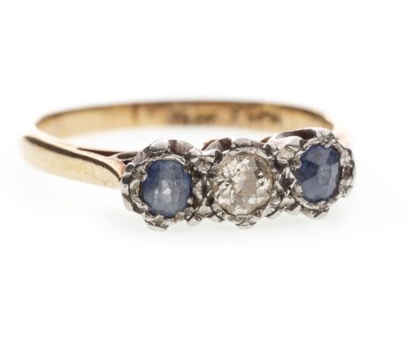 BLUE GEM AND DIAMOND THREE STONE RING, set with a central round brilliant cut diamond flanked by two round sapphires, marked 