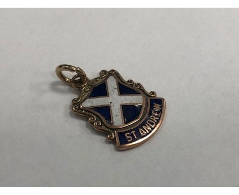 GOLD AND ENAMEL ST ANDREWS CHARM, the shield charm with blue and white enamel decoration, in nine carat gold, 1.2g