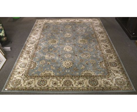 A Turkish Persian Crown Nourison carpet rug. The central panel with floral decoration on a blue ground, bordered by a medalli
