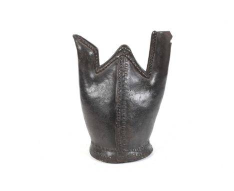 An old leather spouted water flask jug. 'Matara', formed from the hind quarters of and animal with stitching down the middle 