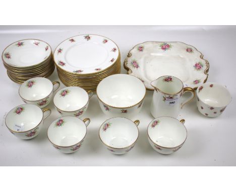 An Aynsley tea service. Decorated with flowers and gilt rims, comprising six cups, twelve saucers, a sugar bowl, cream jug, t