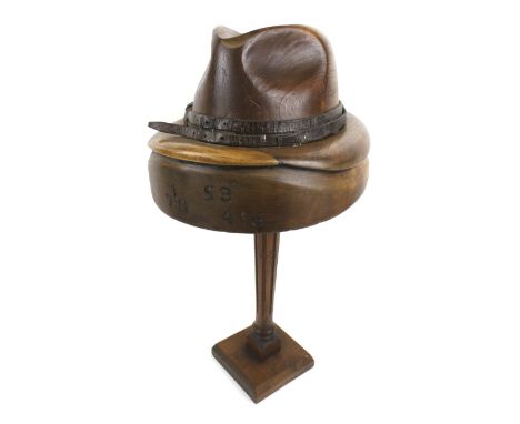 A contemporary carved wooden model of a shop display hat. Mounted on a stand marked '178 S9 416', H50cm