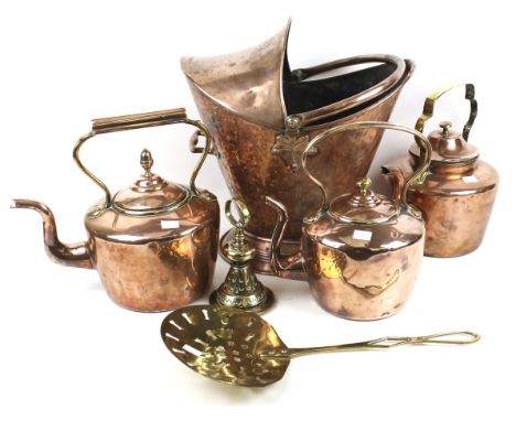 An assortment of 19th century and later metalware. Including three copper kettles, a copper helmet shaped coal bucket, a bras