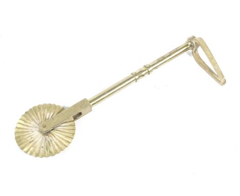 Kitchenalia; large brass pastry crimper. In the form of a wavy edged wheel, the other end of a turned brass shaft having a tr
