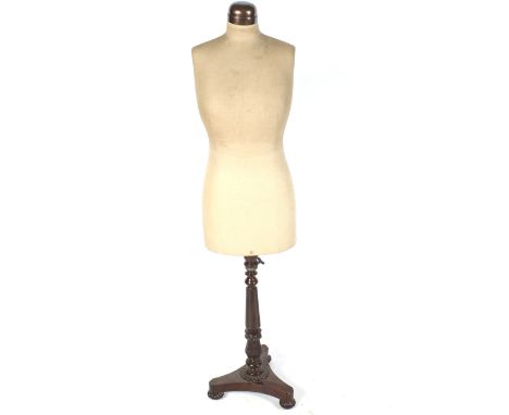 A 20th century dressmakers mannequin. The body stamped '36', mounted on a turned and reeded Regency formed mahogany stand wit