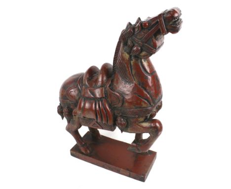 A 20th century carved wooden model of a  Tang horse. Painted in red and mounted on a rectangular base, H54cm