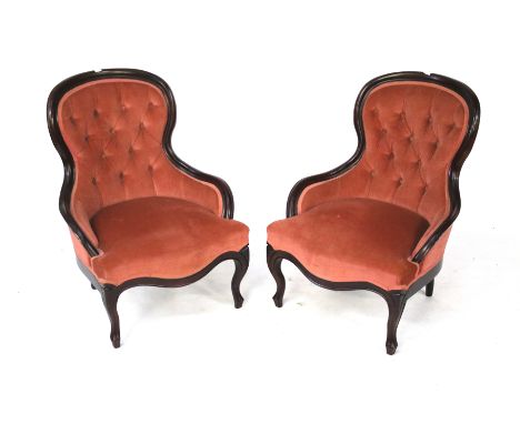 A pair of button back nursing chairs. Upholstered in pink velvet fabric, on cabriole supports, H82cm