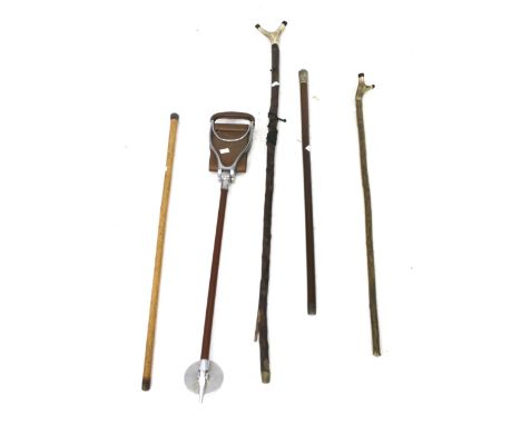 Four walking sticks and a shooting stick. Two of the sticks with antler handles, one with a white metal knop on a malacca sha