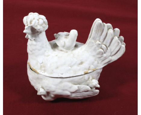 A Victorian ceramic egg holder modelled as a chicken. Glazed in white, containing a paper note regarding the history of the i