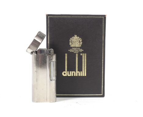  A cased Dunhill silver plateed 's' type lighter. With textured decoration and an old guarantee and instructions, the lighter