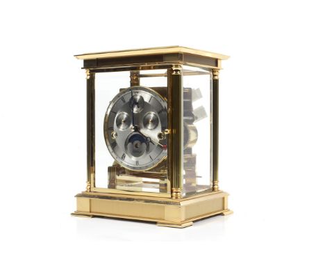 A Kieniger brass chiming mantel clock. The silvered dial with Roman and Arabic numerals, four subsidiary dials, within a bras