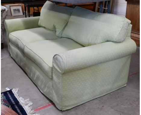 A two seater scroll arm sofa, with patterned green fabric loose covers, 190 x 95 x 80 cm high 