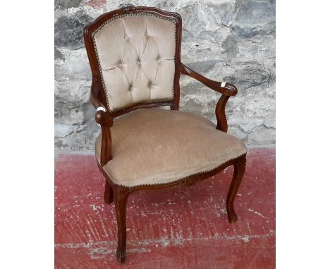 A 20th century button back, material arm chair 